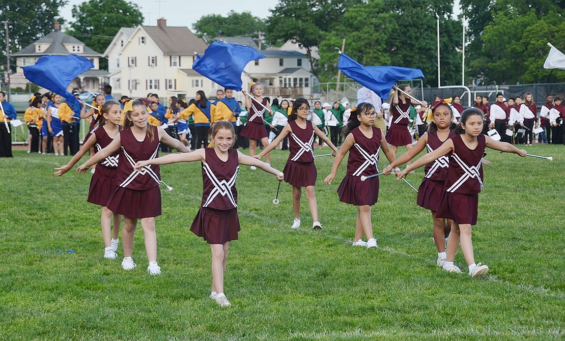 Batons in hand, King Street Elementary School cheerleaders march onto the field in single file lines.