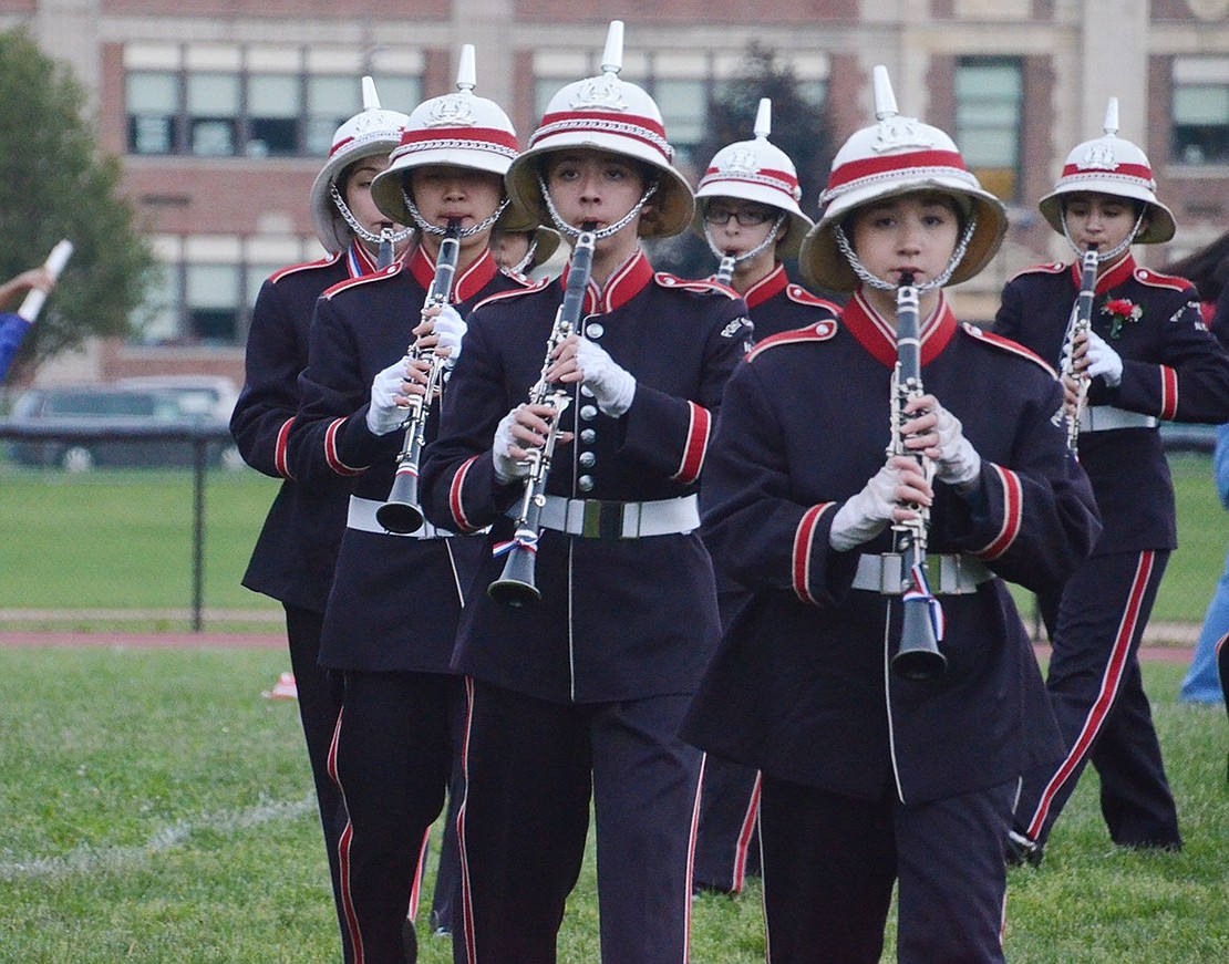 The clarinet section of the Port Chester High School Marching Band wraps around the left side of the field during their routine.