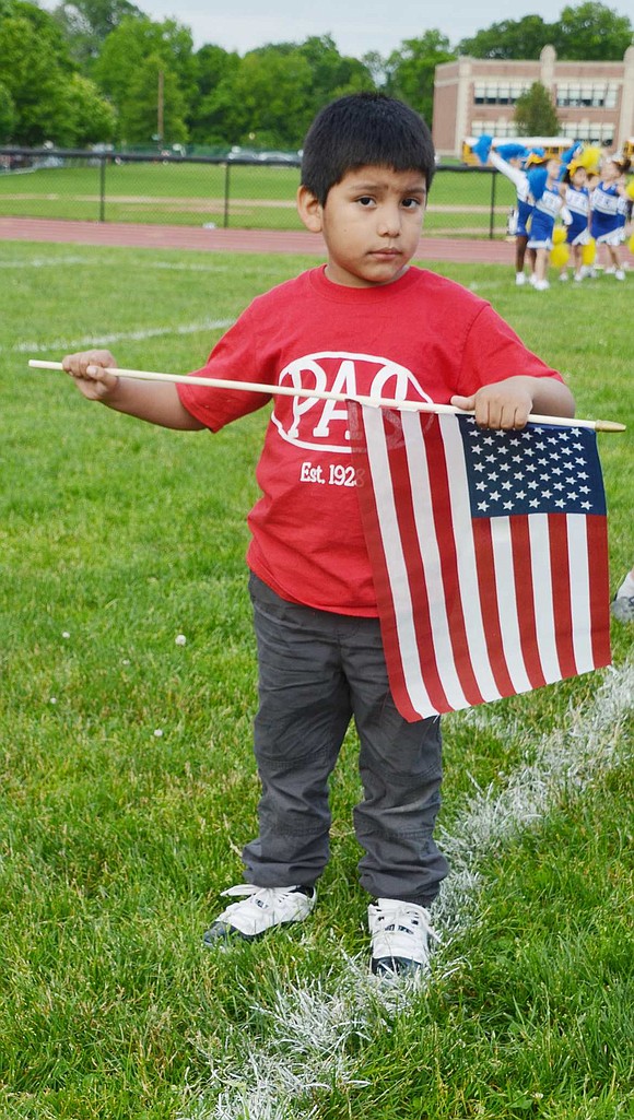 Park Avenue kindergartener Alexander Mendoza is serious about holding his American flag just right. 