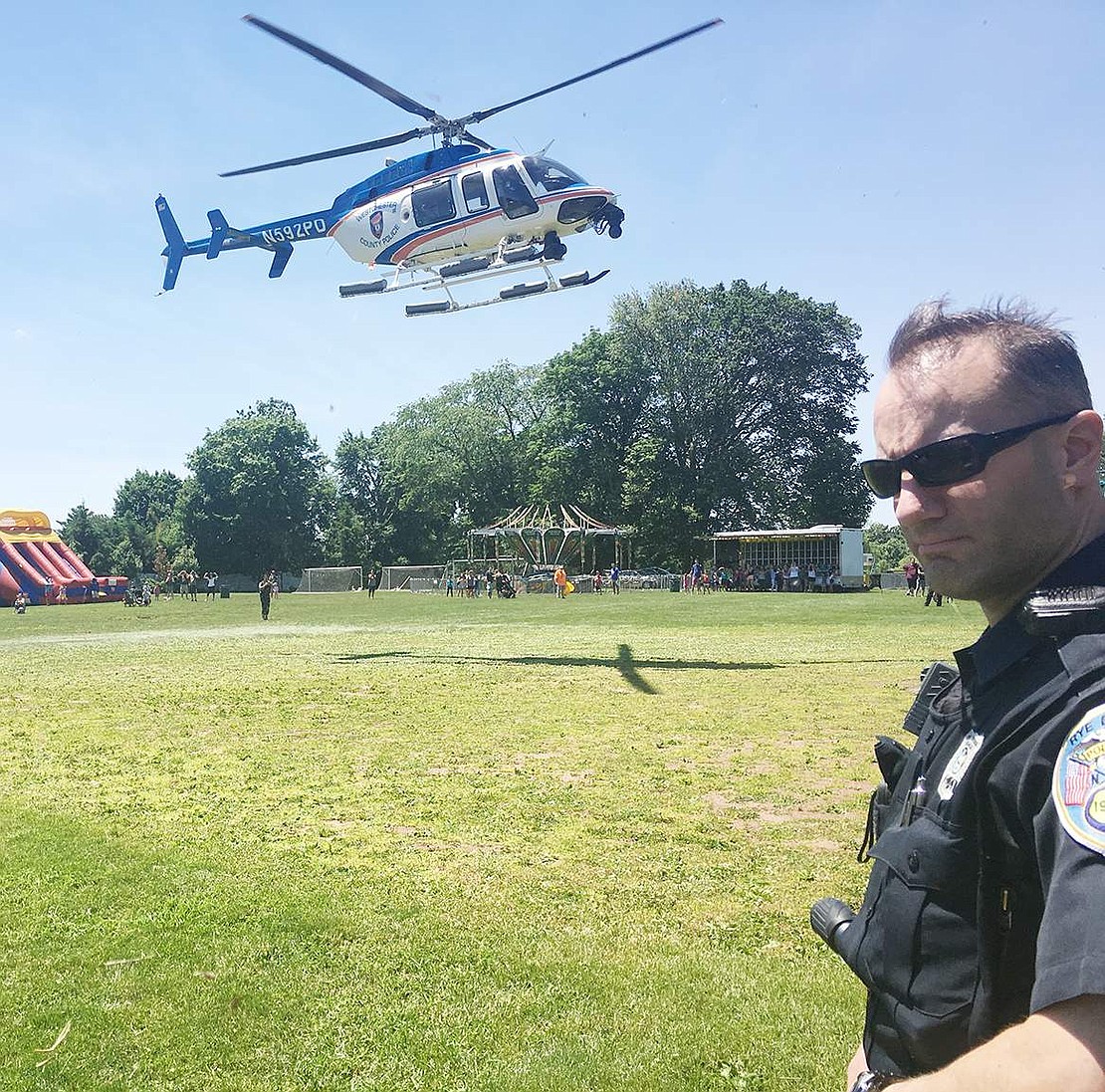 In a true grand entrance to the birthday party, a Westchester County Police helicopter carrying Rye Brook Mayor Paul Rosenberg lands in the middle of Crawford Park in front of Rye Brook Police Officer Michael Caridi. 