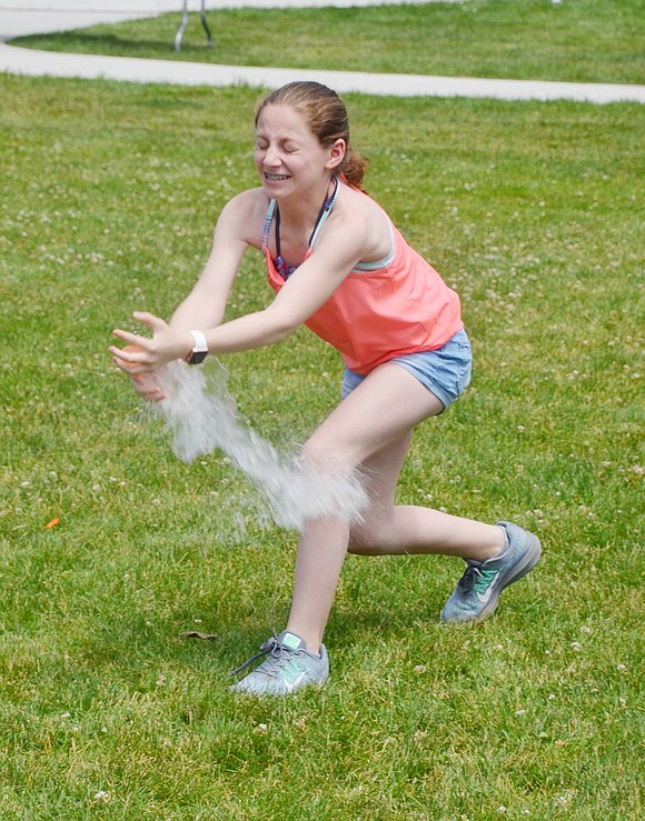 After her water balloon toss partner threw the water balloon from more than 10 feet away, 12-year-old Valley Terrace resident Morgan Salomon nervously yet cautiously catches it. 
