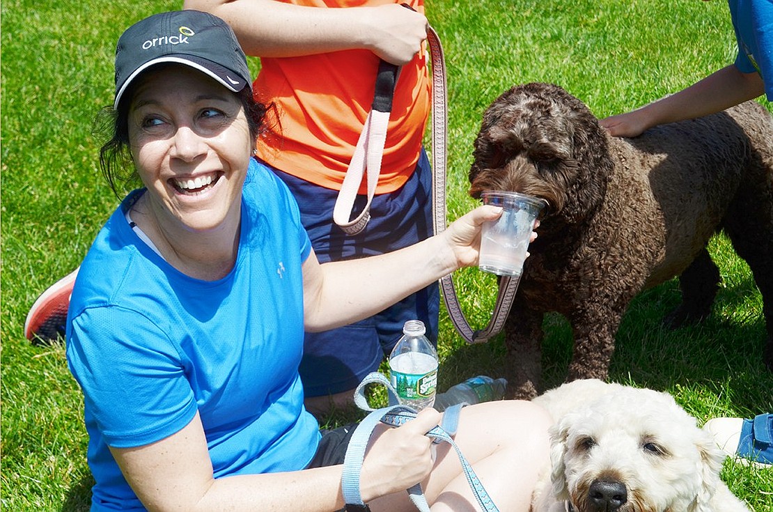 Rock Ridge Drive resident Elyse Berger makes sure her labradoodle Bella is properly hydrated.