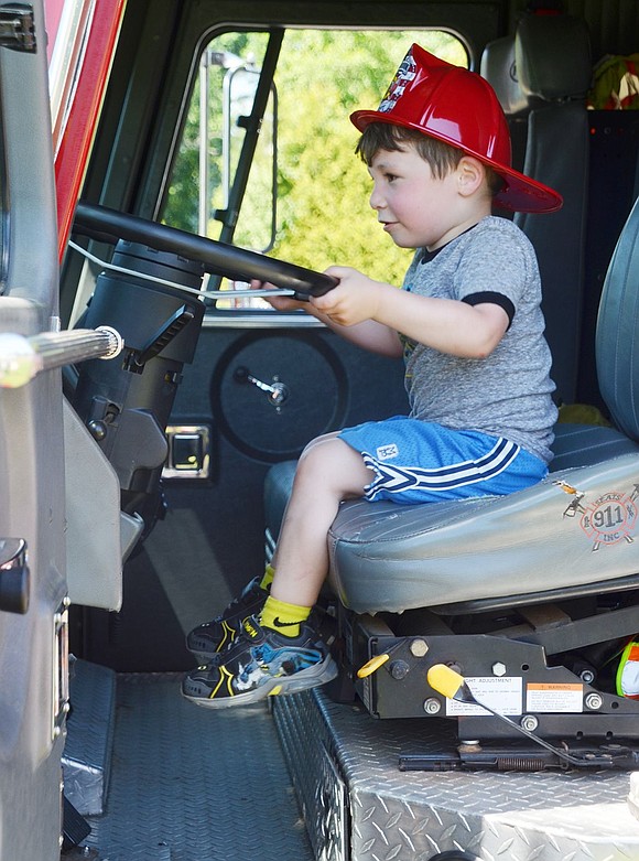 Looks like 3-year-old Rye Brook resident Dylan Stein has a firefighting future ahead as he puts on his red hat and pretends to drive the firetruck. 
