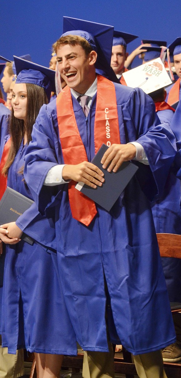 Proud after making his walk across the stage for his diploma during the Blind Brook High School Commencement Ceremony on Thursday, June 21, Jacob Suesserman makes enthusiastic eye contact with a loved one in the crowd at the Purchase College Performing Arts Center. 