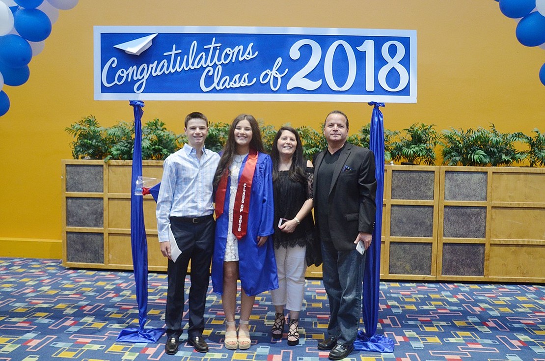 After the ceremony, Isabella Lazar poses with her brother Sam and parents Carol and Mirel under the giant blue and white balloon arch.