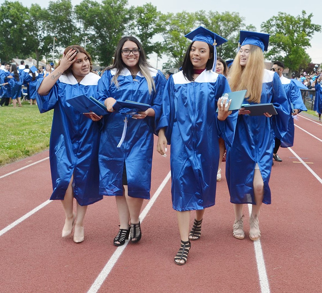 Diplomas in hand and a full future ahead, Stefanie Cruz (left), Mariana Valdovinos, Jennifer Cuevas and Eva De Cicco glamorously walk off the field at Ryan Stadium on Friday, June 22, right after the Port Chester High School commencement ceremony. 