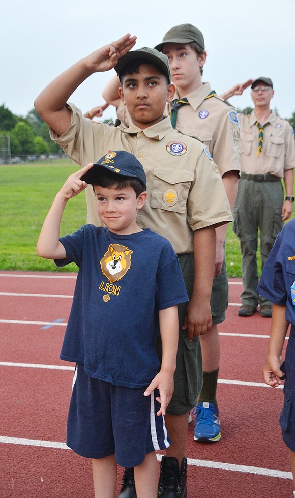 Peter Ayala, 6, of Rye Brook Cub Scout Pack 3 (front) salutes along with Boy Scouts from Port Chester Troop 400 during the Pledge of Allegiance.