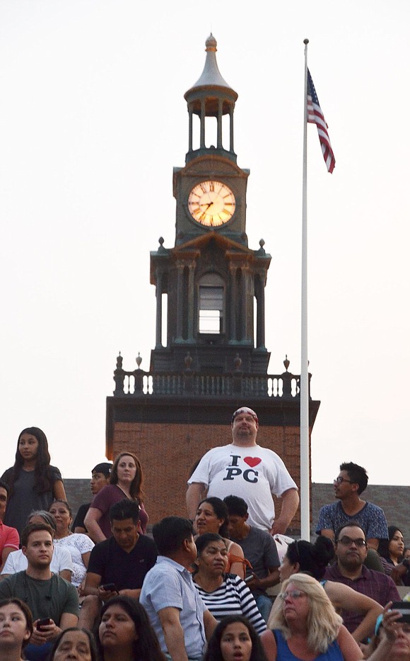 Dave Engleman of Grove Street stands in front of the clocktower at Port Chester High School wearing an I Love PC t-shirt. 