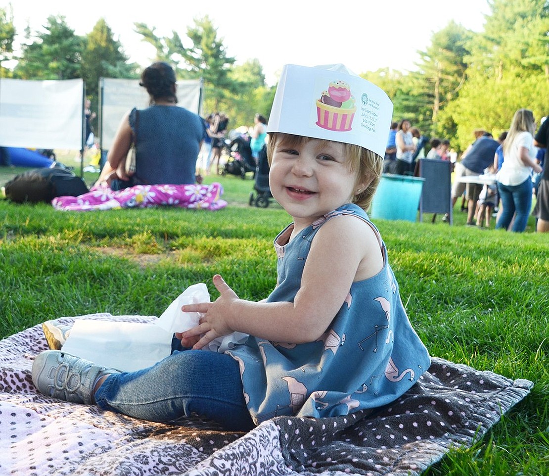 Her smile says it all. One-year-old Ella Rende sports a soda jerk hat embellished with the Ice Cream Fridays’ event logo as she enjoys the evening with her family.