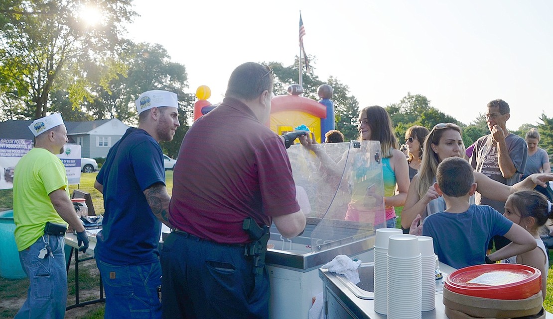 Crowds of people line up to get a free scoop of ice cream at Ice Cream Friday on July 13 at Pine Ridge Park.