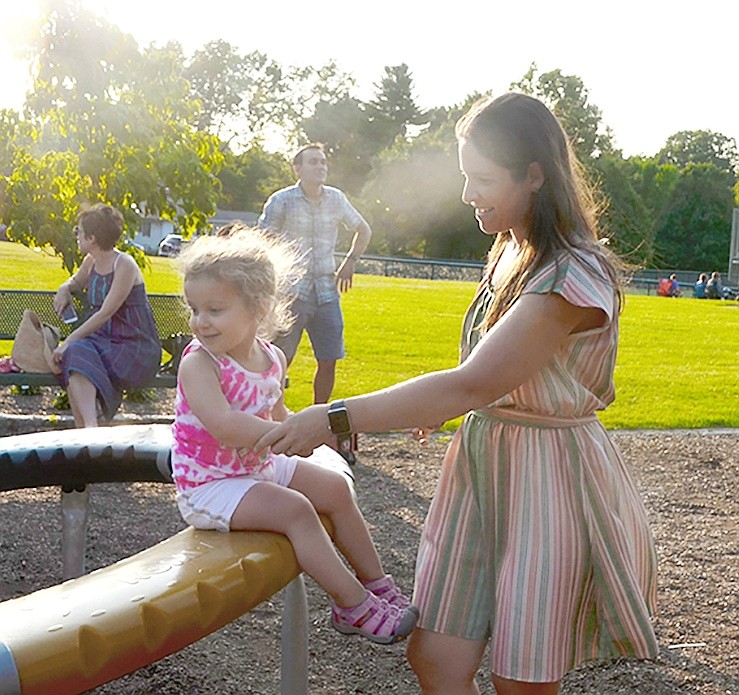 Boxwood Place resident Erica Wiener and her two-year-old daughter Emma enjoy time together on the playground.