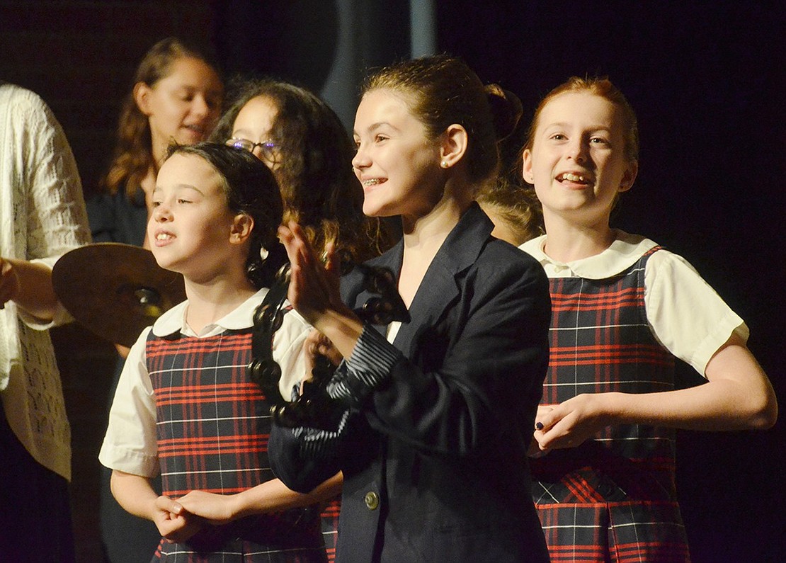 Sarah Brown, played by Lauren Barton, plays the tambourine as she leads her fellow missionaries on stage.  Sarah Wolpoff|Westmore News 