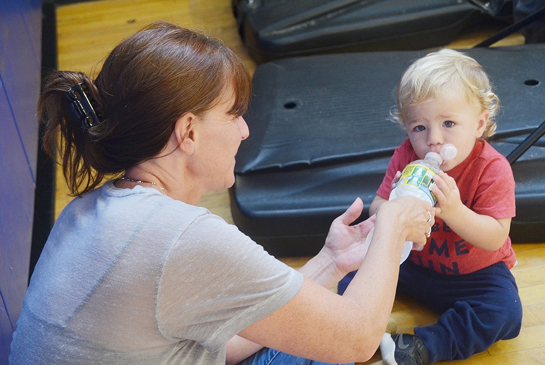 Sleepy Hollow resident Paxton Pell gets thirsty just from watching the Port Chester and Tarrytown high schoolers sweat it out on the basketball court. Good thing his grandma Christine Good is there to help the 1-year-old with his water bottle.