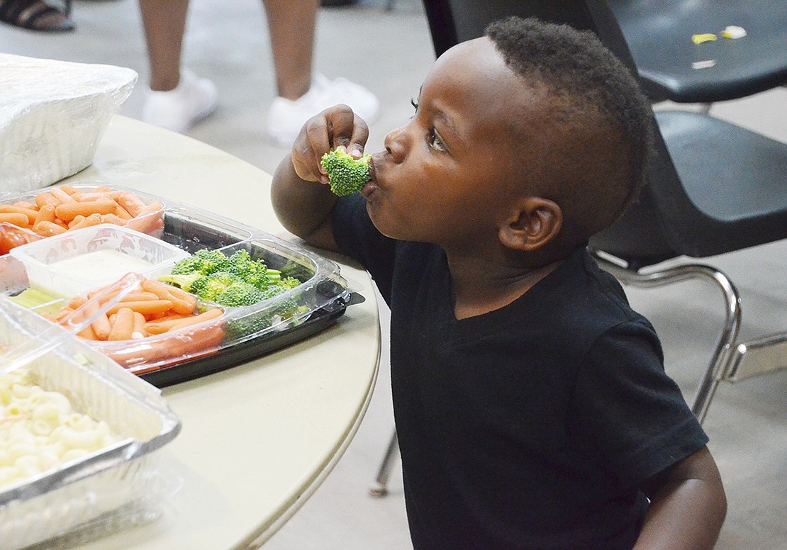 Two-year-old Weber Drive resident Levi Nichols can’t resist the broccoli—but maybe first just a taste. 