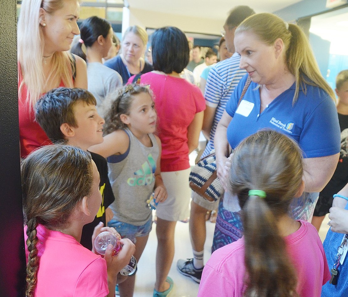 After realizing all the Hamlet quadruplets have names starting with “M,” Ridge Street Elementary School fourth-grade teacher Allyson Bal tests her spelling abilities to make sure she has Madison (back), Michael, Marissa and Michelle’s names right. The fourth-grade teacher is mingling with all the siblings at the Blind Brook Federation of Teachers-sponsored Meet and Greet on Wednesday, Aug. 29, though only Marissa will be in her class starting Tuesday, Sept. 4.