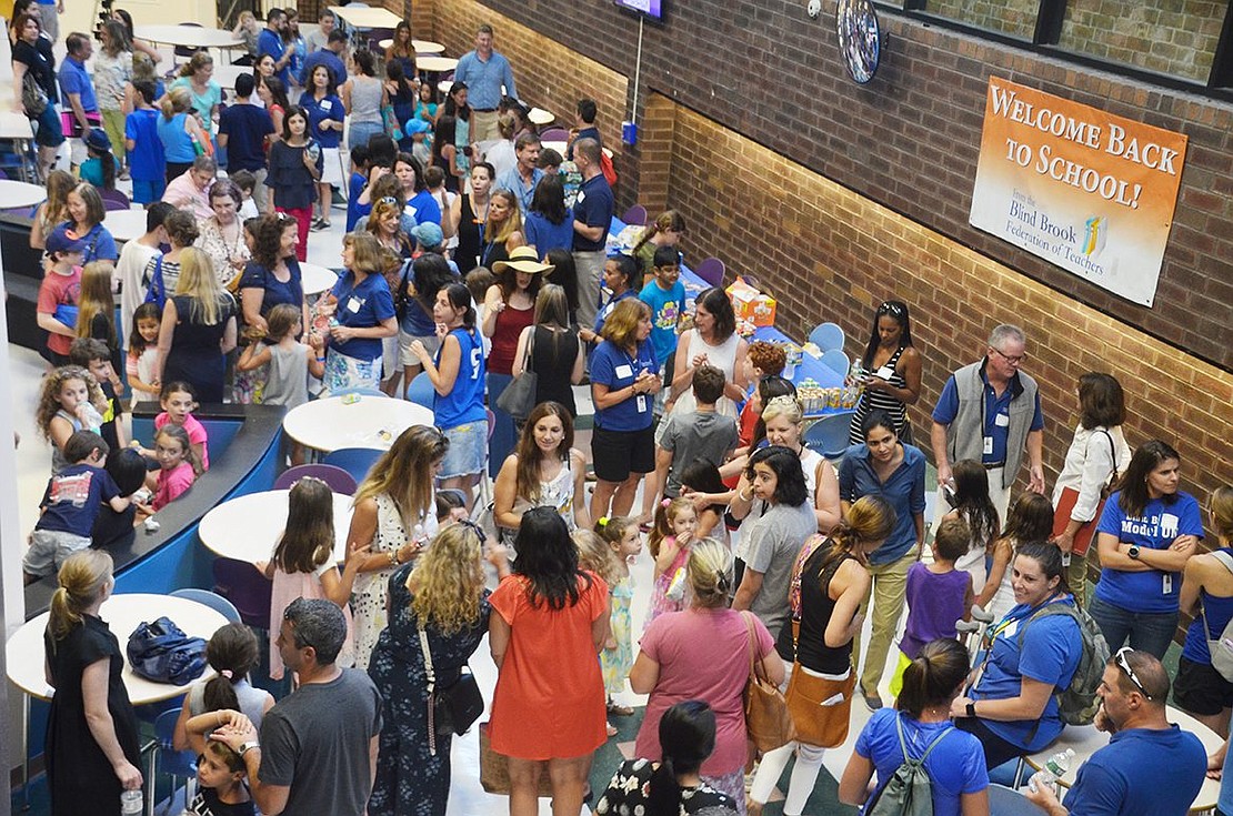 Due to the extreme heat, hundreds of teachers, students and parents attending the annual Blind Brook Meet and Greet cram inside the Middle/High School Commons as opposed to gathering in Harkness Park as usual.