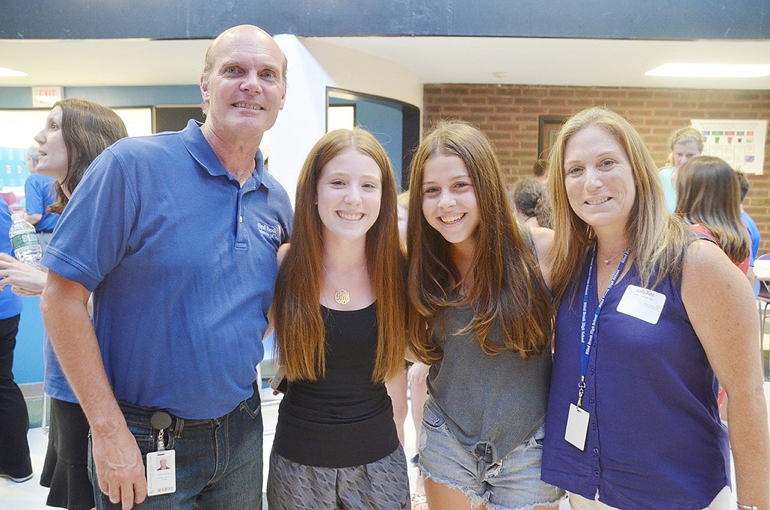 The Meet and Greet isn’t just for introducing students to their new teachers. High School freshman Olivia Zahl poses for a photo with her mother, a friend and the eighth-grade math teacher she “always wanted but never had.” From the left: math teacher Jim Tamucci, freshman Olivia Zahl, freshman Shira Mallan and math teacher Cindy Zahl. 