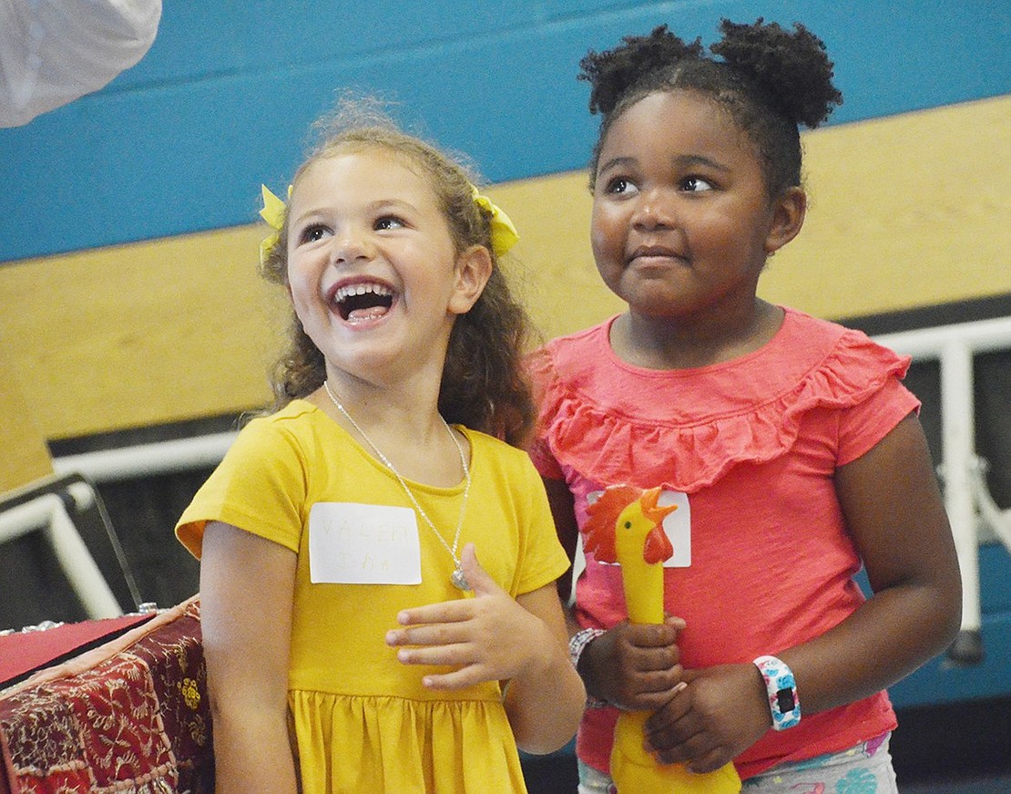 After getting called on stage as volunteers for a rubber chicken and top hat related trick, Valentina Castellano is absolutely delighted. Her new friend Eliana James, however, seems a little more skeptical of the magic.