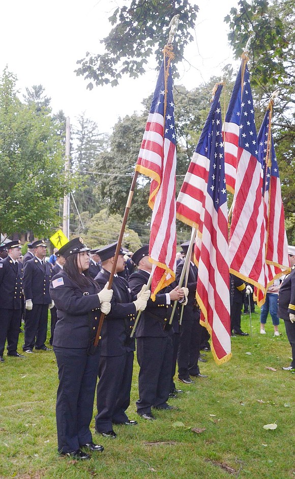 Rye Brook resident Esmeralda Perez attentively stands with several other uniformed volunteer firefighters preparing to present the colors.