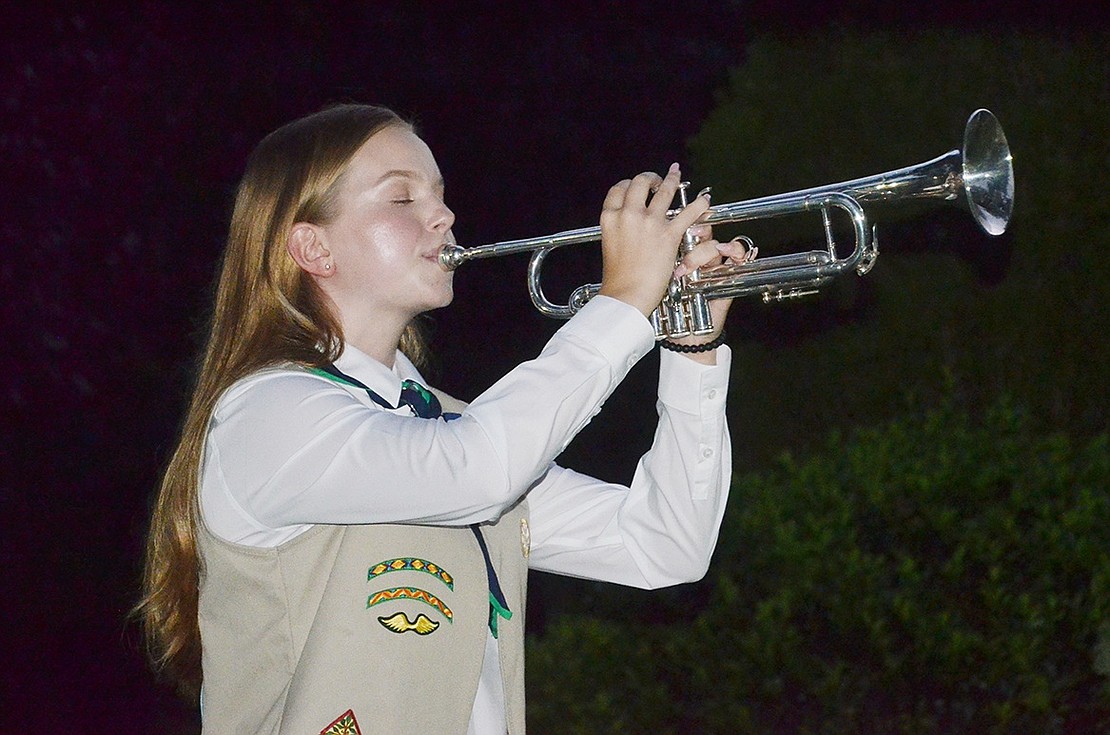 To honor those lost, Port Chester High School junior Molly Brakewood soulfully plays Taps on her trumpet.