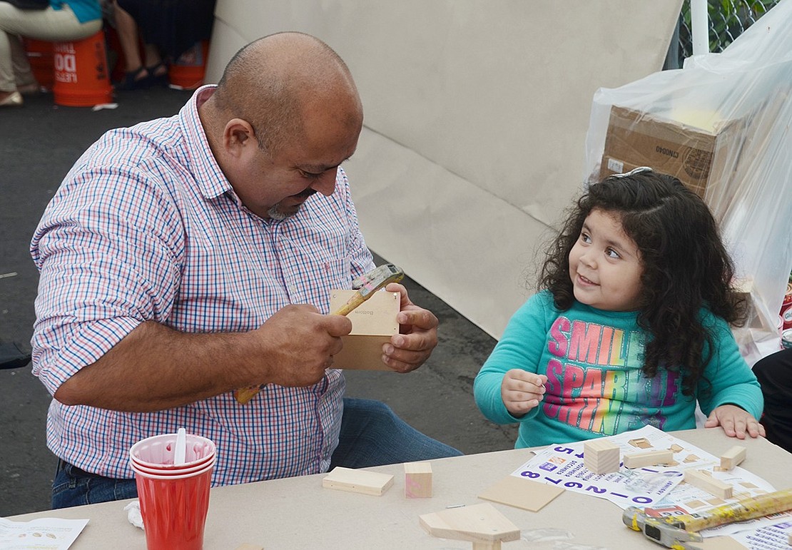 Even though she’s eager to start building at the Home Depot arts and crafts table, 3-year-old Port Chester resident Melani Leyva isn’t quite ready to use the hammer. So, she’s more than happy to let her father Jorge help during the Second Pentecostal Church’s fourth annual International Food Day festival in the parking lot behind 58 Poningo St. on Sunday, Sept. 9.