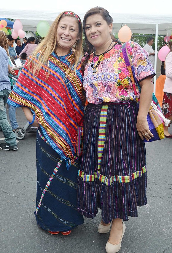 Silvia Buezo (left) and Doris Bolanos stop for a moment to show off their vibrant Guatemalan dresses. Though the women reside in Greenwich, Conn., they are regular parishioners of the Second Pentecostal Church.
