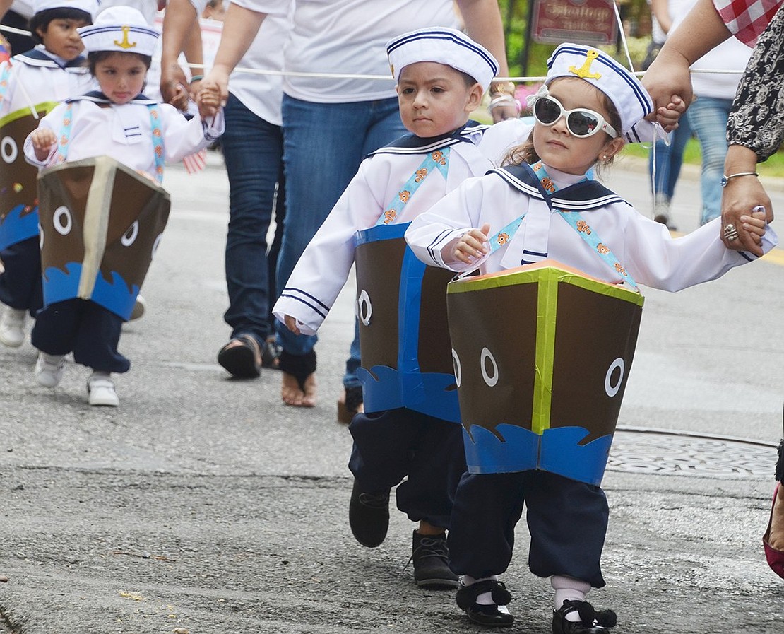 With stylish sunglasses, a sailor suit and fish-themed suspenders, Bent Avenue resident Harper Gonzalez takes Westchester Avenue by storm in her boat costume. The 3-year-old is leading several other toddlers from Lady Bug Family Daycare down Westchester Avenue during the 112th annual Columbus Day Parade on Sunday, Oct. 7.