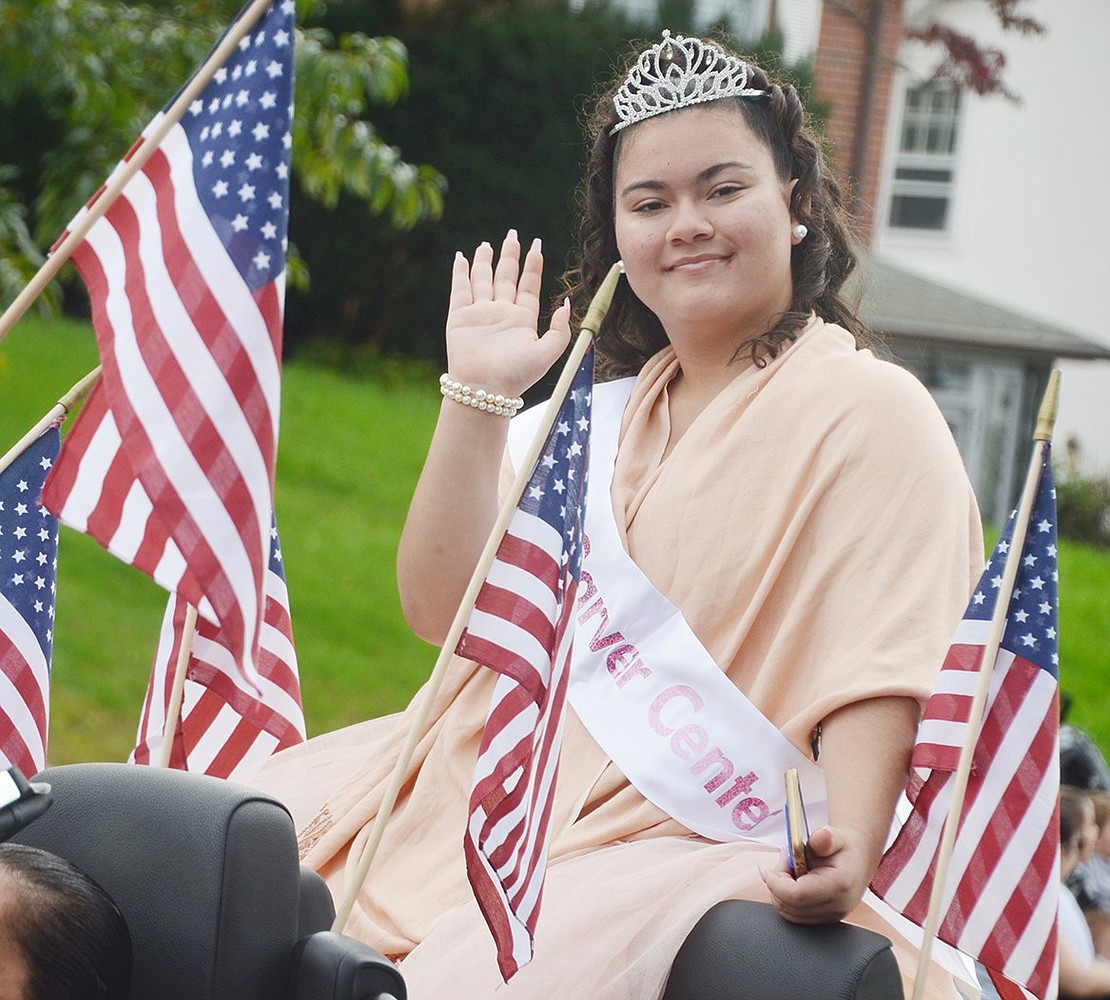 While rocking the sash and tiara, Miss Carver Center and Grace Church Street resident Mariah Lucas, 17, fashionably makes her way down the street in a black BMW convertible.