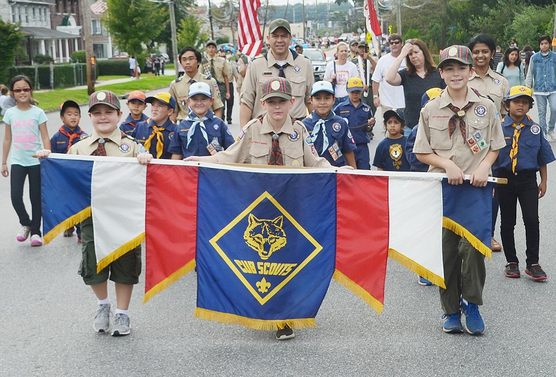 Several Boy Scout troops got in on the Columbus Day festivities. Josh Simkin (left), Brian Sciurba and Martin Agala lead Cub Scout Pack 3 of Rye Brook.