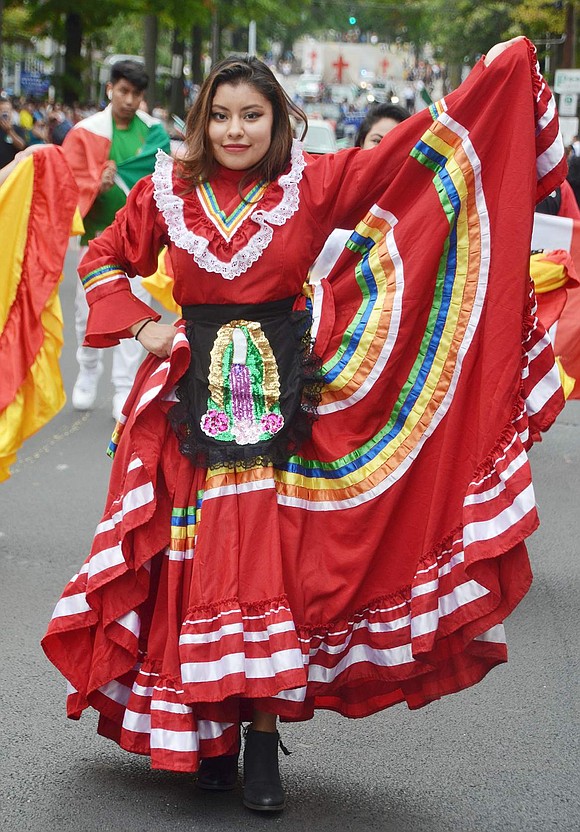 While dancing with the Comitiva Guadelupana Port Chester group, Oak Street resident Leslie Cruz, 22, takes a moment to show off her gorgeous Mexican dress.