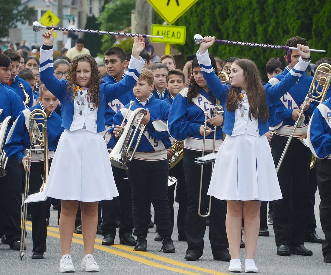 To bring the band to a halt, Port Chester Middle School Marching Band drum majors Jenna Provenzano (left) and Gwen Dominguez firmly hold their batons above their heads.