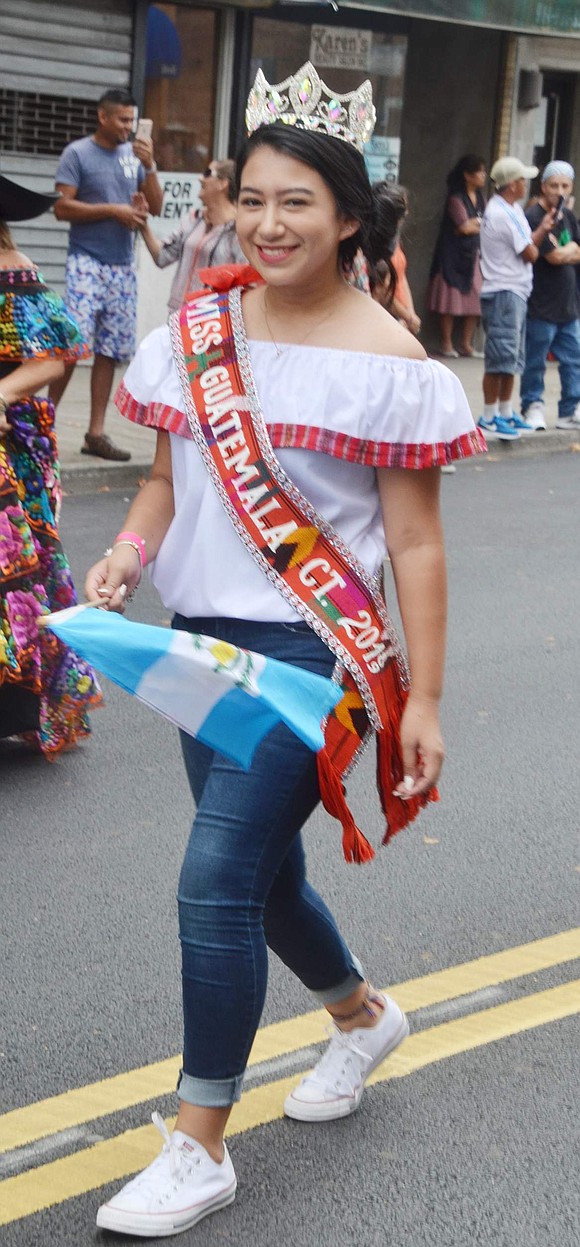 Stamford, Conn. resident Nicole Rodas joins in on the fun to walk down Westchester Avenue as Miss Guatemala.