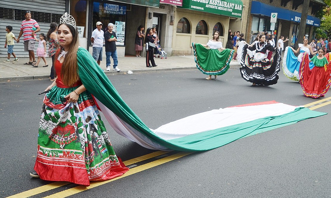 Though she just moved to Port Chester, Yesica Diaz is already joining the community by leading Comitiva Guadelupana dancers in her stunning dress with a long Mexican flag tail.
