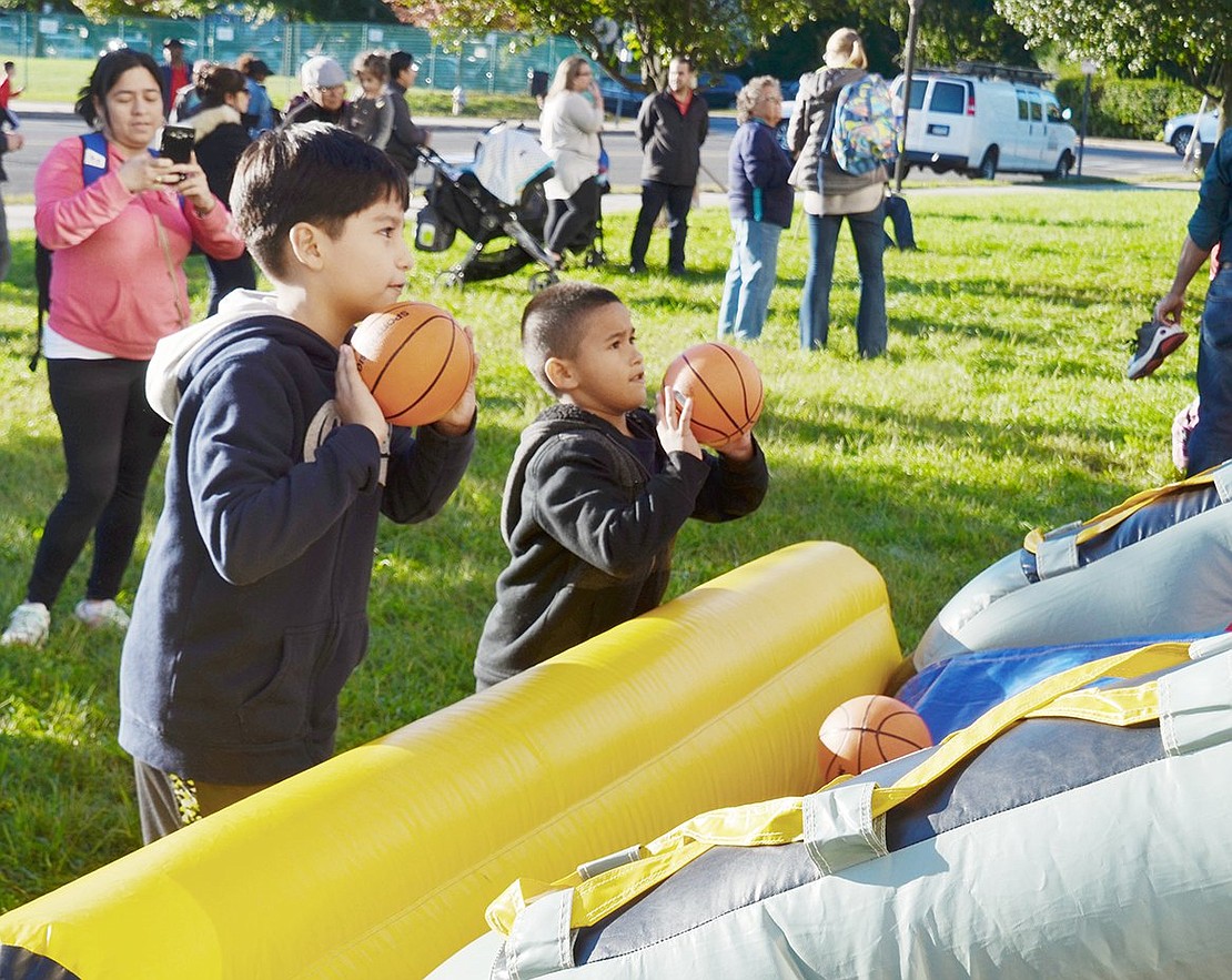 Concentration is key when it comes to basketball, evident by John F. Kennedy School fourth-grader Sergio Morales (right) and Park Avenue kindergartener Gael Guevara’s faces as they prepare to shoot some hoops.