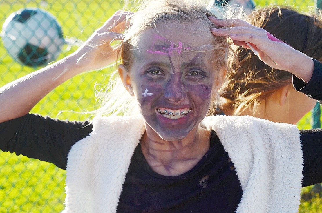 Girl, zombie, or both? Park Avenue Elementary School third-grader Mary Mateus shows off her spooky purple face paint.