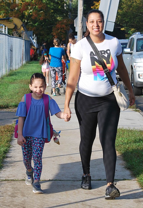 Michelle Pereira holds her daughter Chelsea’s hand as they trudge up Upland Street toward King Street School on International Walk to School Day, which this year fell on Wednesday, Oct. 10. Chelsea is a kindergartner and they walked from King Street where they live. Over half of the elementary school’s 456 students made their way to school on foot on this day dedicated to teaching students the benefits of doing so.