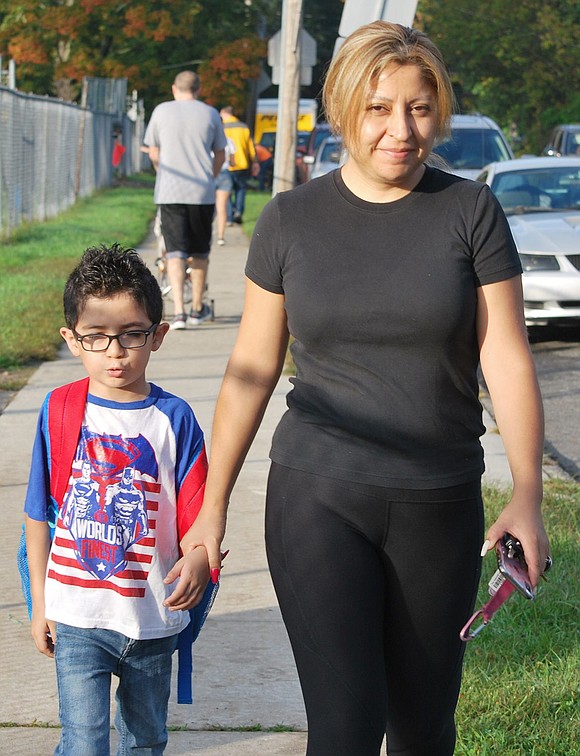 Fanny Oliveros walks with her son Daniel, who is in first grade, up Upland Street to King Street School. They live on Maple Place but did not walk the whole way to school. Fanny parked on an adjacent street and they hoofed it the rest of the way.