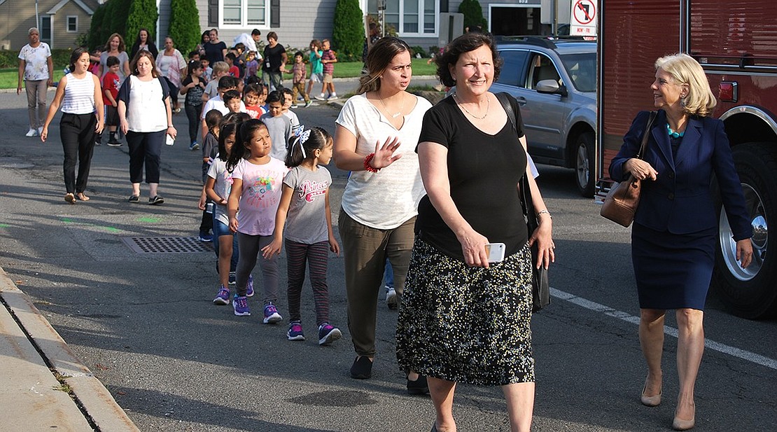 State Senator Shelley Mayer, at right, and County Legislator Nancy Barr are at the front of a group of students and teachers making their way around the King Street School driveway following a ceremony in which local, county and state officials presented proclamations and made remarks about the benefits of walking to school. This workout allowed all students, even those who arrived by bus or otherwise could not walk to school, to get some exercise.