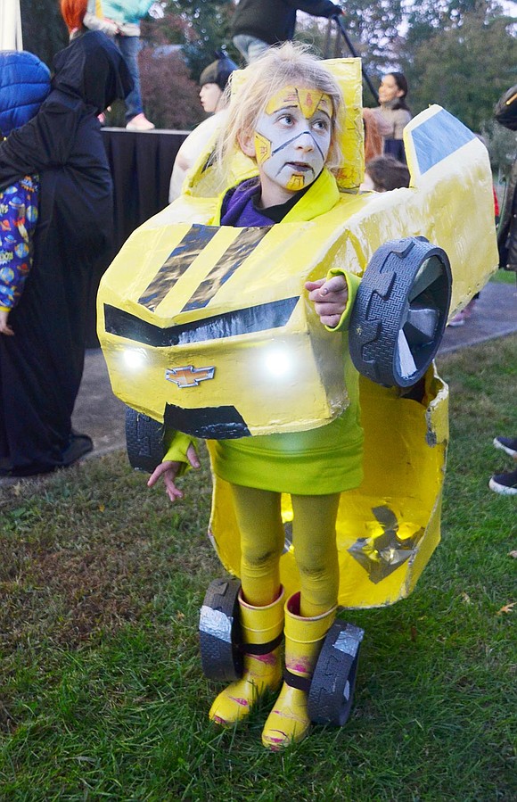 One minute Putnam Avenue resident Abby Roux is a car, the next she’s a world-saving robot. The French-American School third-grader’s viable Transformers getup won first place in the costume contest at Halloween in the Park at Lyon Park on Wednesday, Oct. 24.