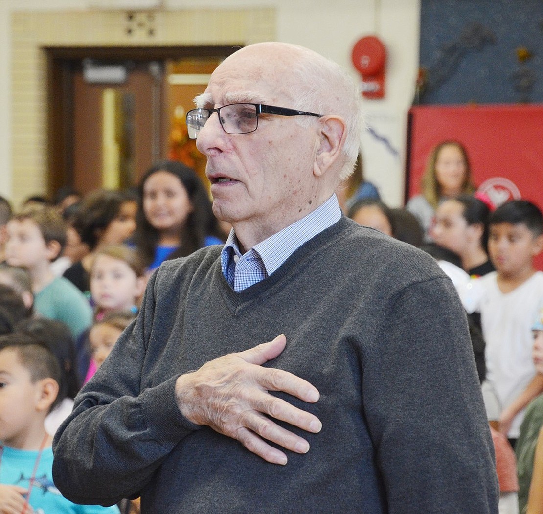 Silvio Buccieri, a lifelong Port Chester resident who served in the U.S. Army stationed in Germany after World War II, places his hand on his heart and sings along with the National Anthem during the Park Avenue School ceremony.