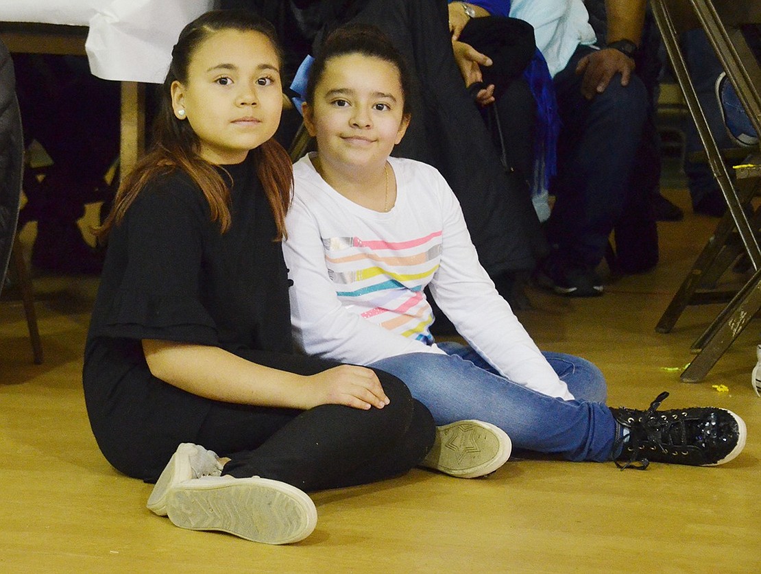 After dinner, fifth-grader Sofia Rangel (left) and fourth-grader Kamila Jimenez wait patiently for the show to begin. Sarah Wolpoff|Westmore News 