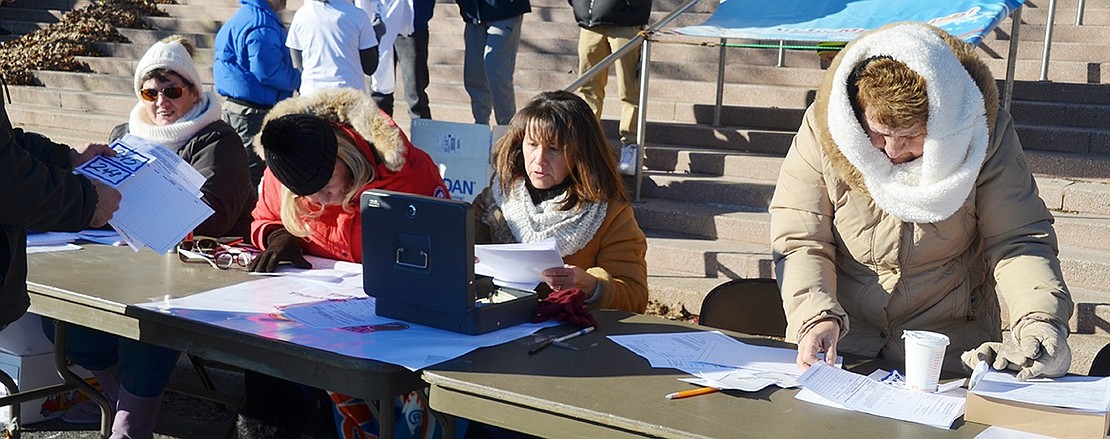 Tamarack Tower Foundation board members Denise Quinn, Karen Corbetta, Margoth Pilla and Joan Conklin are bundled up against the cold at the registration table for the annual Turkey Trot on the coldest Thanksgiving in 100 years.