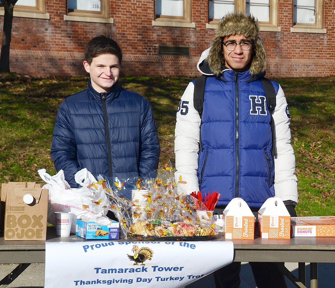Port Chester High School sophomore Thomas Ross and junior Isaac Valdovinos, members of the newly rekindled Key Club, man the refreshment table.