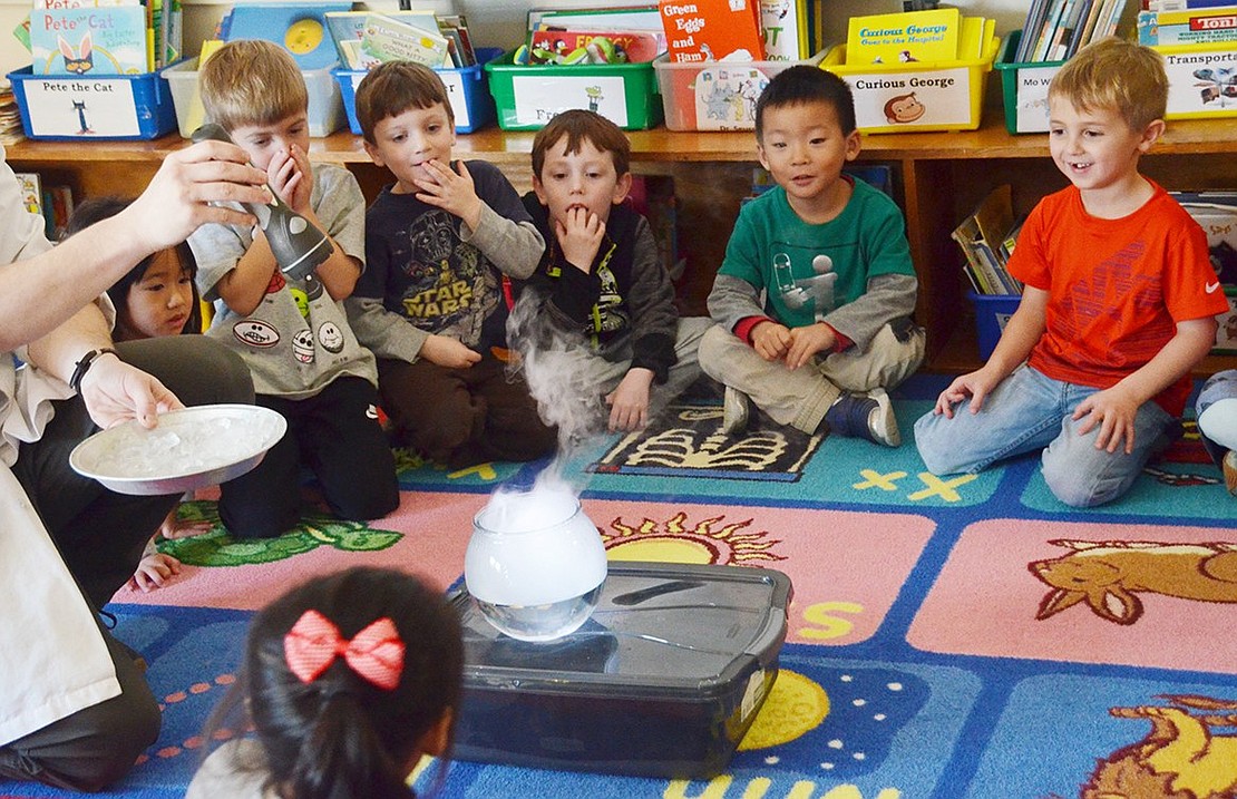 After Brad Line puts a plate of ice over a bowl of boiling water, several students in Lisa Mecca’s class gather around in utter shock to see a rain cloud unleashed in their own classroom.