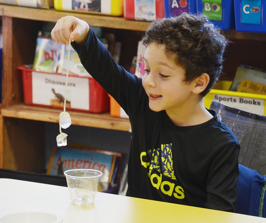 When students received a personal experiment to sprinkle salt over ice and a string to try and make an adhesive, Marcus Smith is gleeful to see it worked.