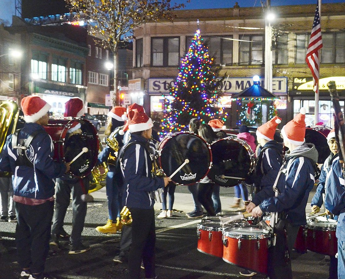 The Pride of Port Chester drum line does a drum roll while Port Chester Mayor Richard Falanka leads the crowd of hundreds in a countdown to light the Christmas tree across the street in Liberty Square. The 24-foot spruce was donated by Mitchell Place resident Lynn Alvarez.