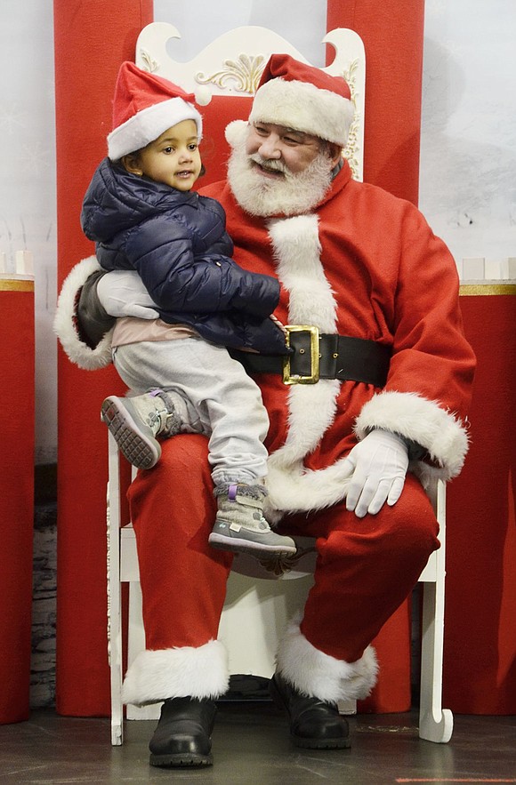 Port Chester resident Juliana Robinson, a 4-year-old, bypassed the present line to be the first one to meet Santa Claus, played by Charlie Sacco.