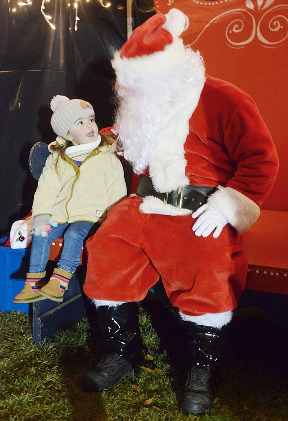 At first Natalie Georges was hesitant to approach Santa Claus (played by John Giordano), but once the 2-year-old Winding Wood Road resident sits next to him, she’s more than happy to disclose her Christmas wishes during the annual Winterfest at Pine Ridge Park on Friday, Dec. 7.