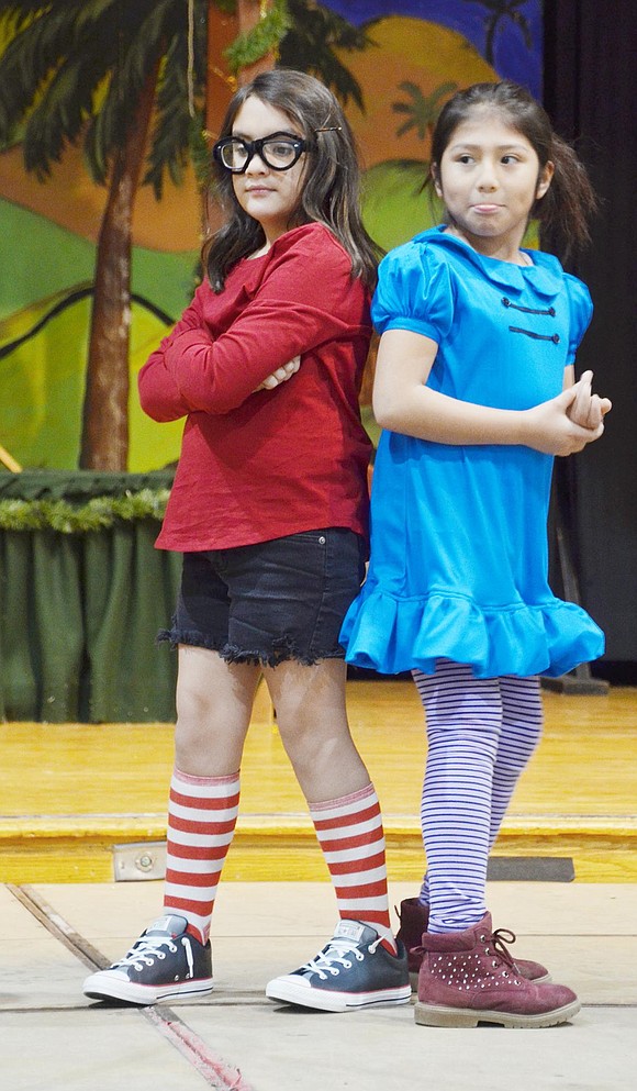 After singing “The Chipmunk Song,” Marcie (left) and Lucy, played by Milena Martinez and Keyla Guayllasaca, strike a back-to-back pose.