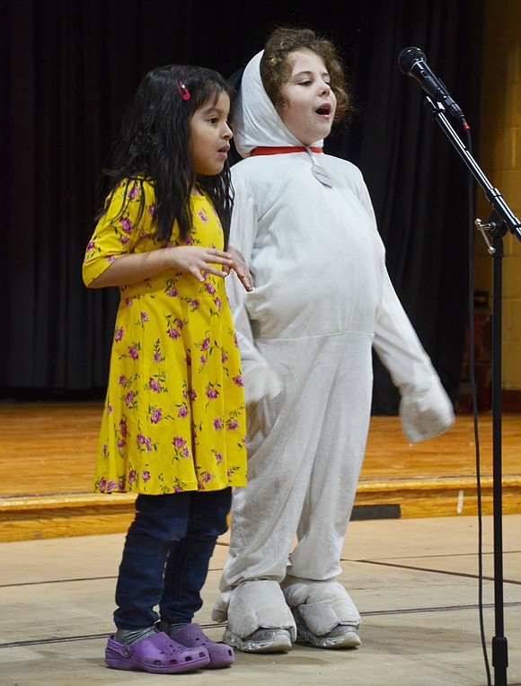 The iconic bird and beagle duo Snoopy and Woodstock, played by Natalie Budde and Mariana Tenecela, dynamically sing “Jingle Bells.”